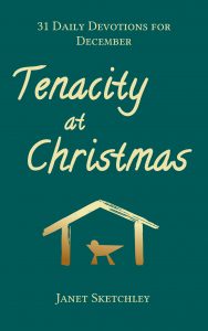 Book cover: Against a green background, a golden outline of a manger in a shelter. Text: Tenacity at Christmas: 31 Daily Devotions for December, by Janet Sketchley